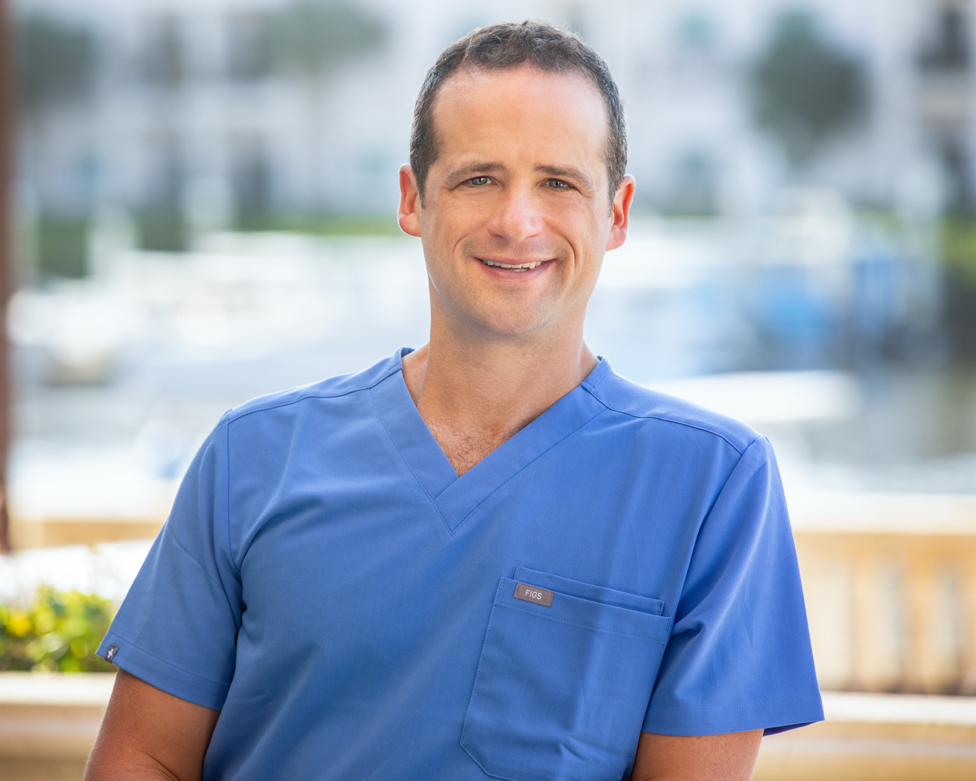 Brandon Kirsch, MD, wearing blue scrubs